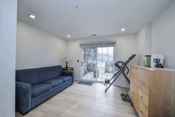 a living room with furniture gym equipment and a view of living room