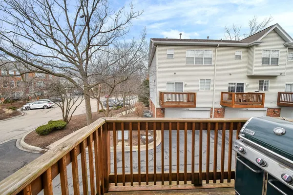 a view of a brick house with wooden fence