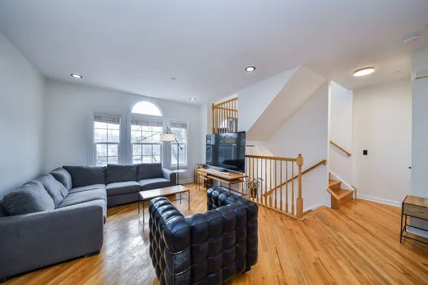a living room with furniture and wooden floor