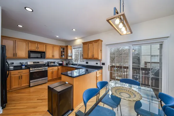 a kitchen with stainless steel appliances granite countertop a stove and a refrigerator