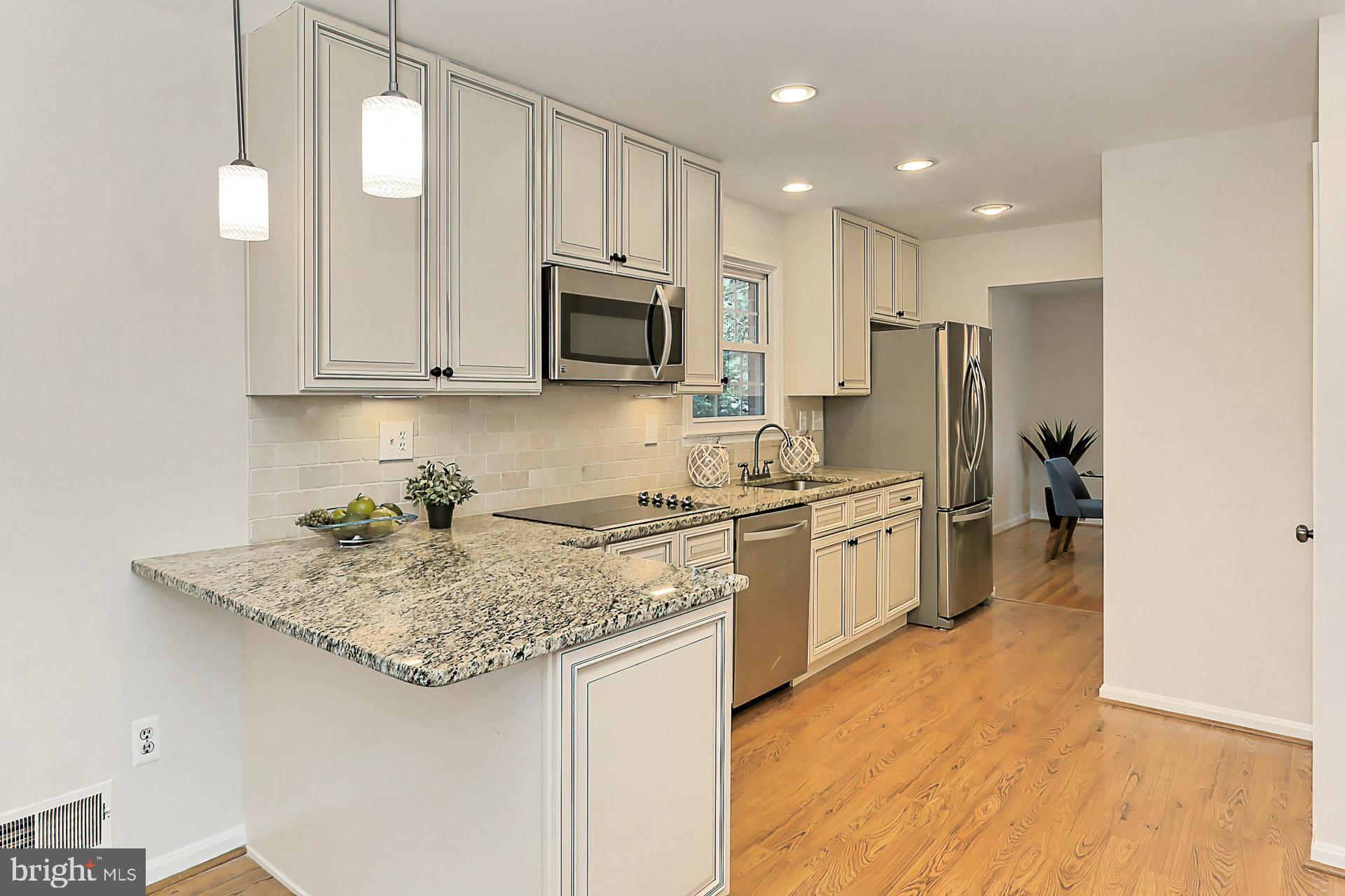6808 Sydenstricker Road Springfield, VA 22153 - Photo 17 of 65 Breakfast bar with pendant lighting