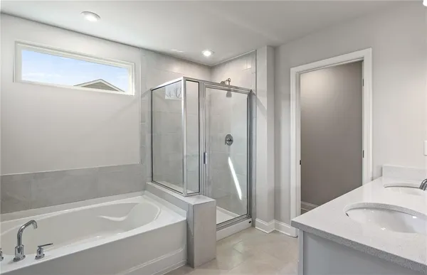 a bathroom with a tub a sink and a shower