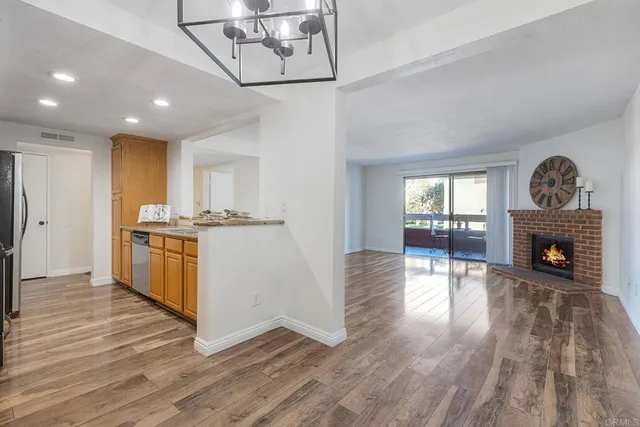 a view of kitchen with microwave and wooden floor