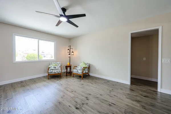 a living room with furniture and a wooden floor