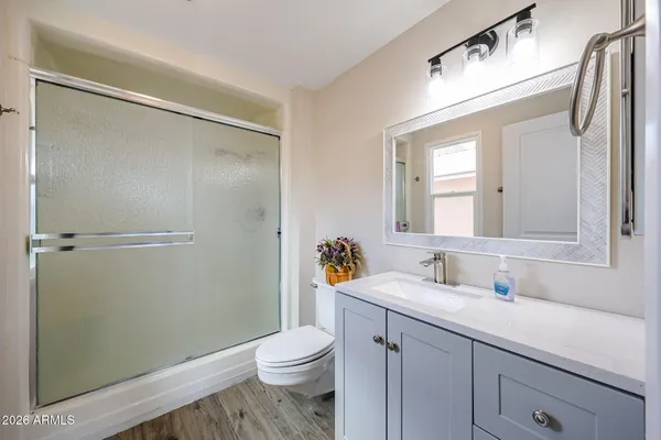 a bathroom with a sink a toilet and shower
