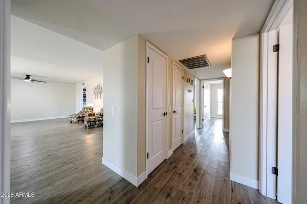 a view of a hallway view with wooden floor and living room