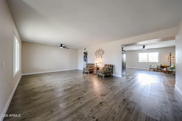 a view of a livingroom with furniture and hardwood floor