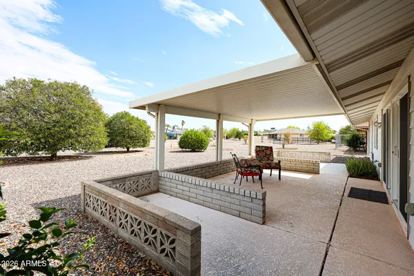 a view of a patio with a table chairs and a patio