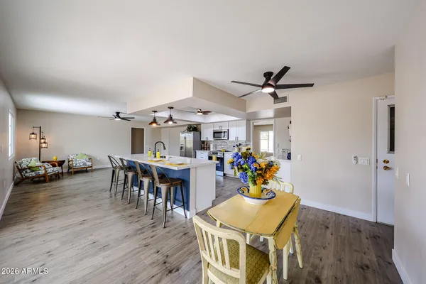 a view of a dining room with furniture and wooden floor