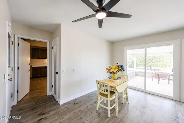 a dining room with furniture a chandelier and wooden floor