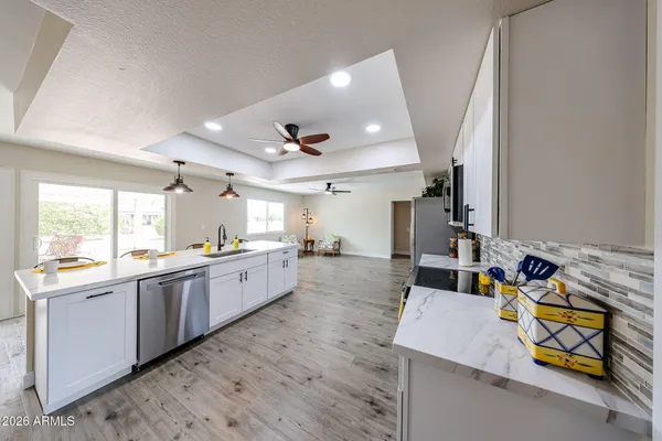 a large kitchen with kitchen island a sink stainless steel appliances and cabinets