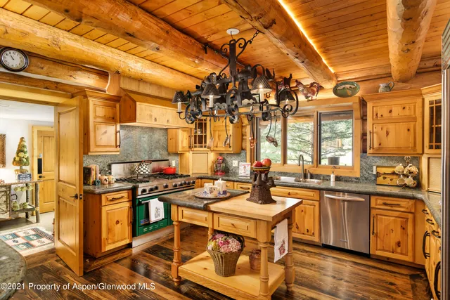 a view of a patio with glass top table and chairs