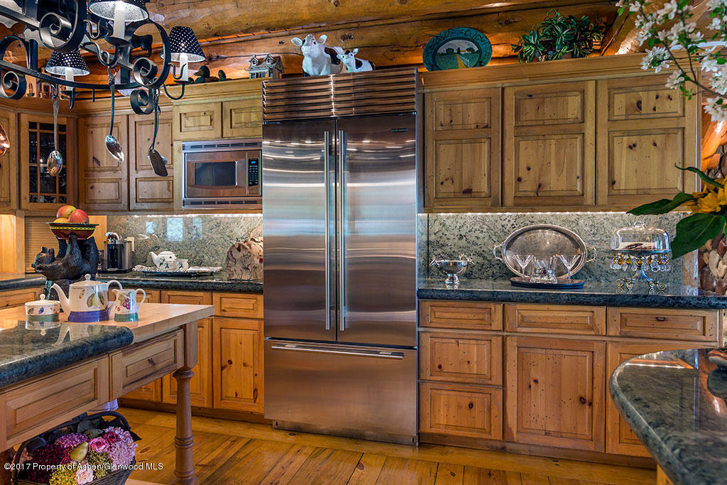 770 Twining Flats Road Woody Creek, CO 81611 - Photo 14 of 59 a kitchen with granite countertop stainless steel appliances and wooden cabinets