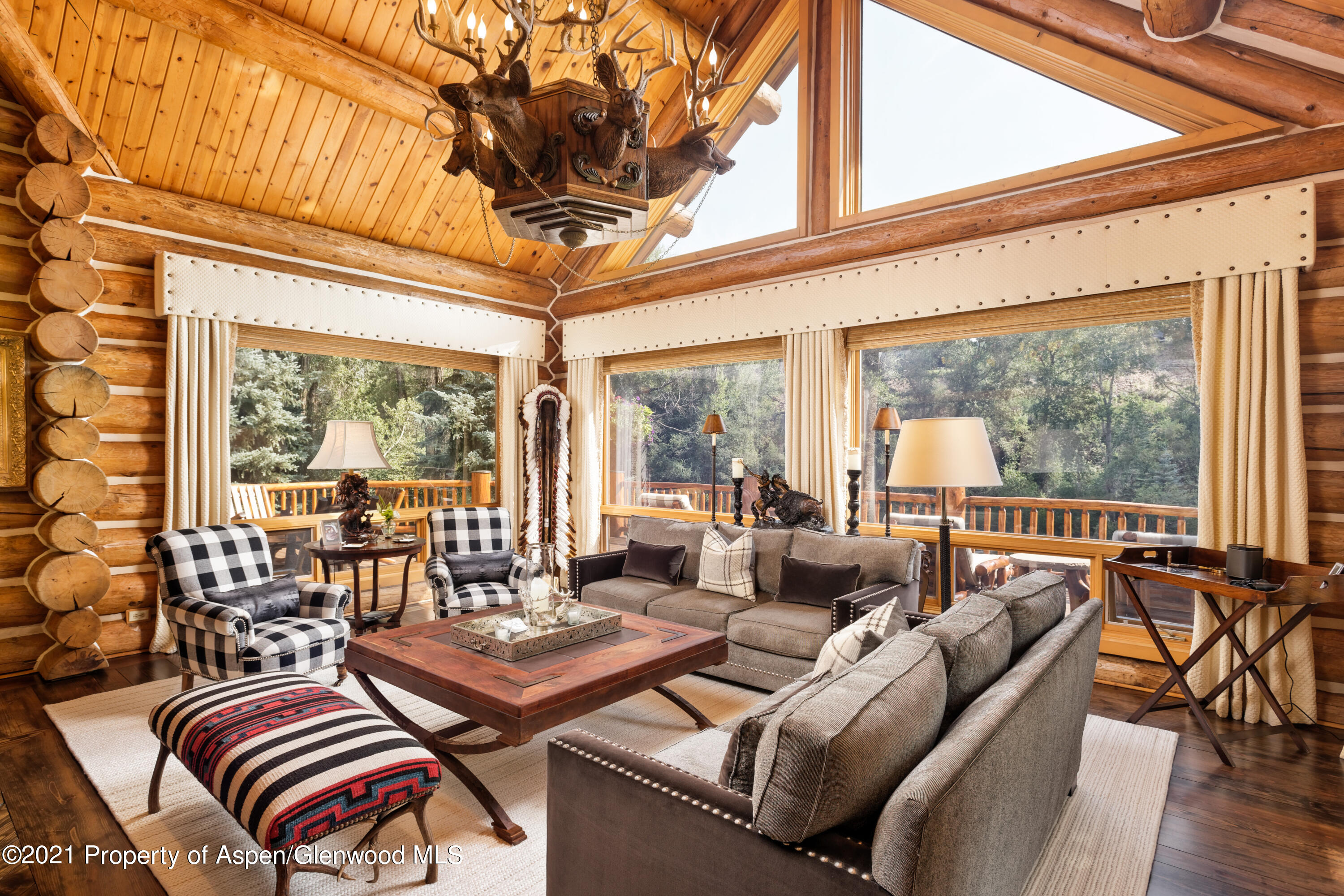 770 Twining Flats Road Woody Creek, CO 81611 - Photo 16 of 59 a living room with furniture a rug and a large window