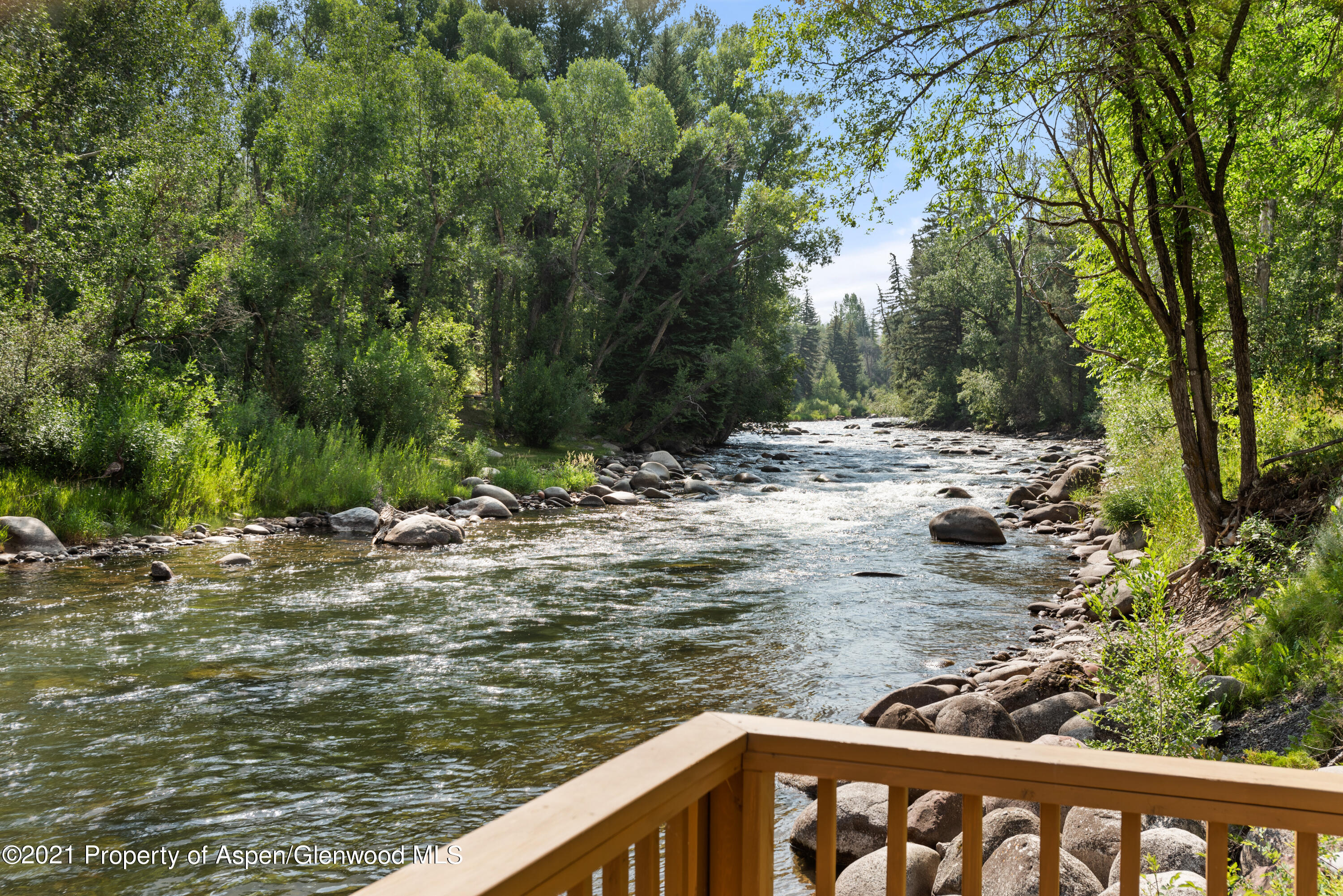 770 Twining Flats Road Woody Creek, CO 81611 - Photo 2 of 59 a view of a lake with a tree