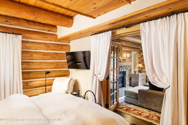 a living room with furniture a fireplace and a floor to ceiling window