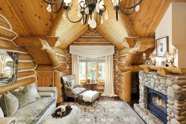 a bed sitting in a spacious bedroom next to a window