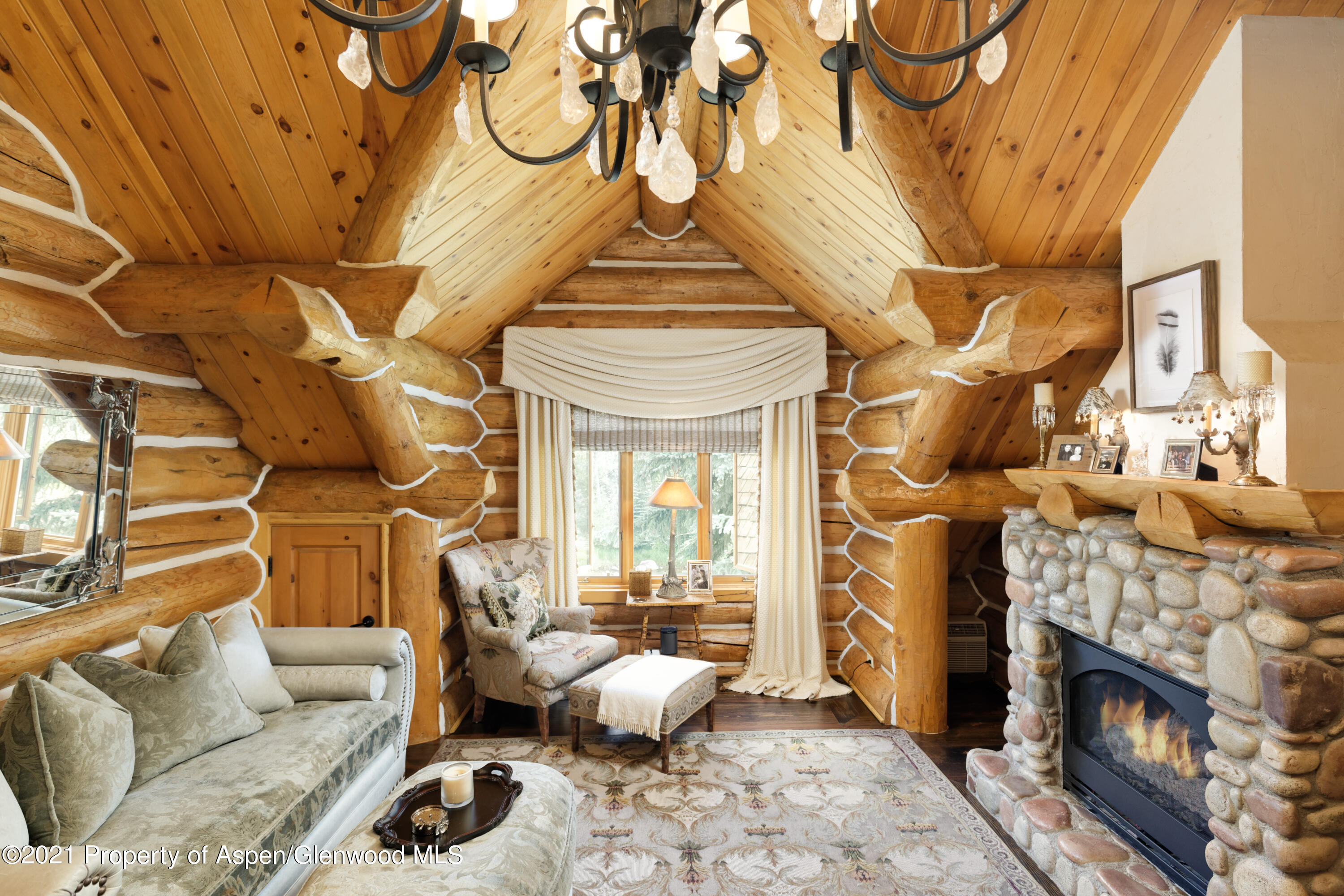 770 Twining Flats Road Woody Creek, CO 81611 - Photo 25 of 59 a living room with furniture a fireplace and a floor to ceiling window