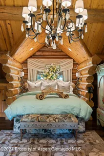 a bathroom with a tub a sink and a large mirror