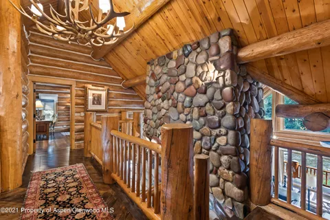 a bedroom with two beds and a flat screen tv