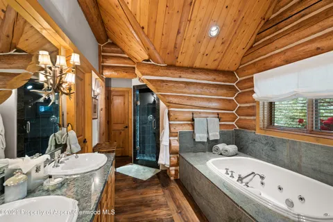 a living room with furniture a large window and a chandelier