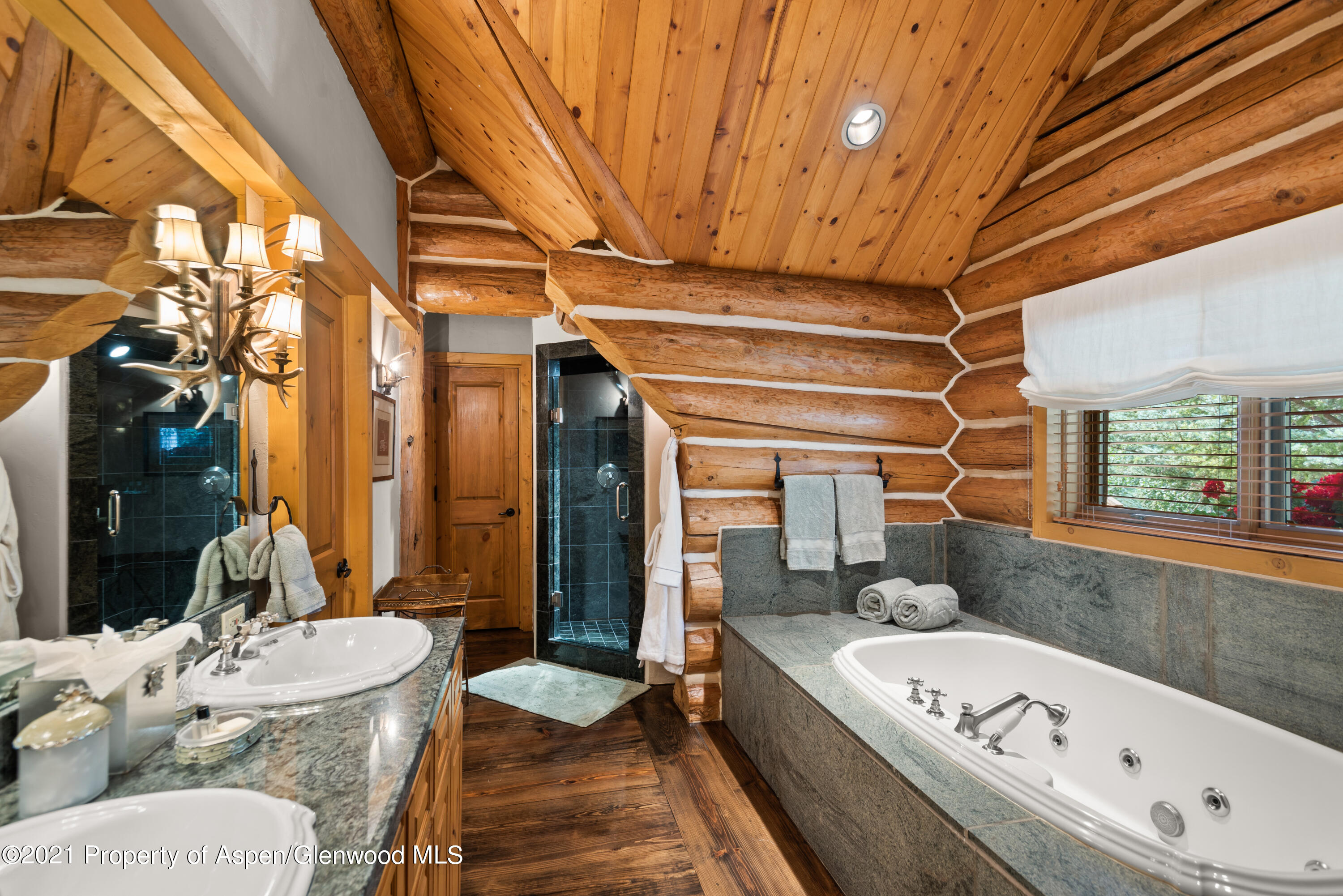 770 Twining Flats Road Woody Creek, CO 81611 - Photo 32 of 59 a bathroom with a tub a sink and a large mirror
