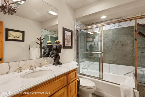 a bedroom with two beds and a chandelier