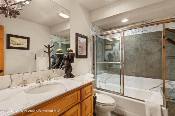 a bedroom with two beds and a chandelier