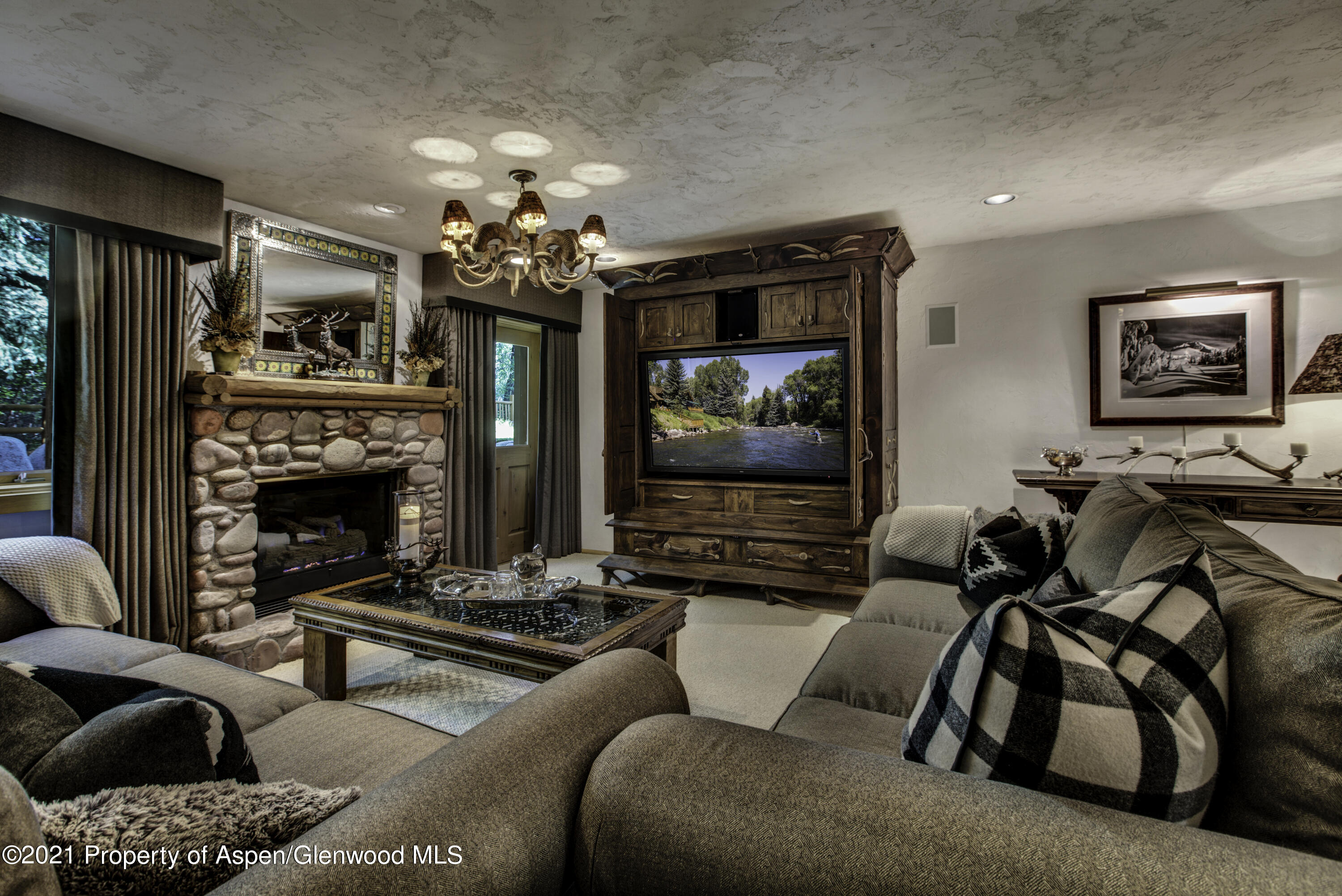 770 Twining Flats Road Woody Creek, CO 81611 - Photo 37 of 59 a living room with furniture and a fireplace