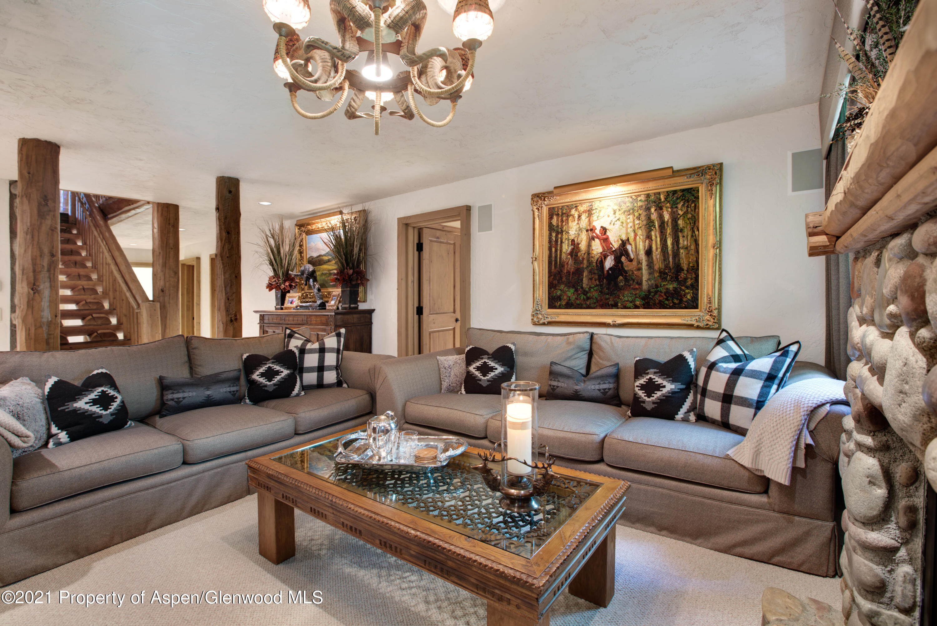 770 Twining Flats Road Woody Creek, CO 81611 - Photo 38 of 59 a living room with furniture a large window and a chandelier