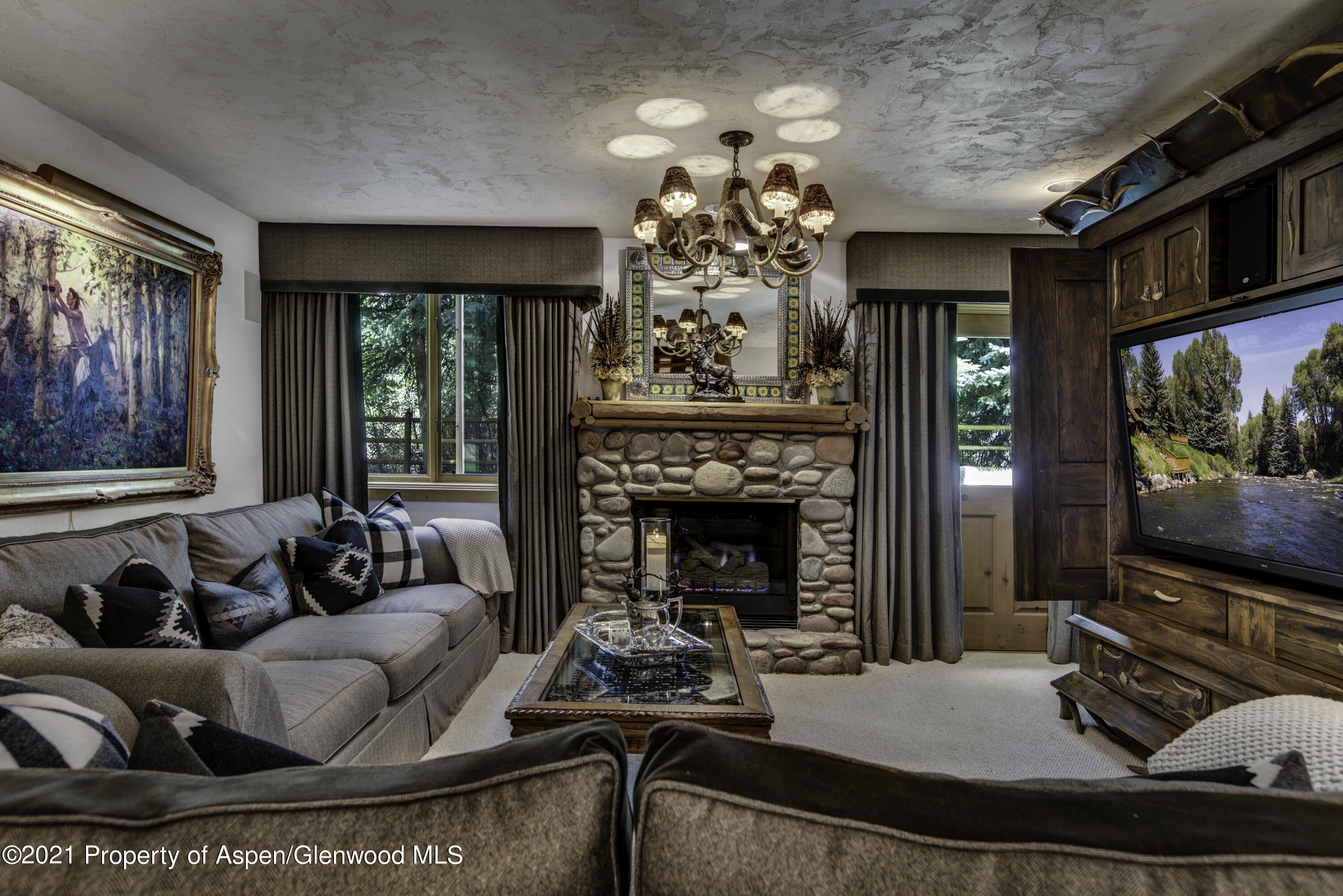 770 Twining Flats Road Woody Creek, CO 81611 - Photo 39 of 59 a living room with furniture and a flat screen tv