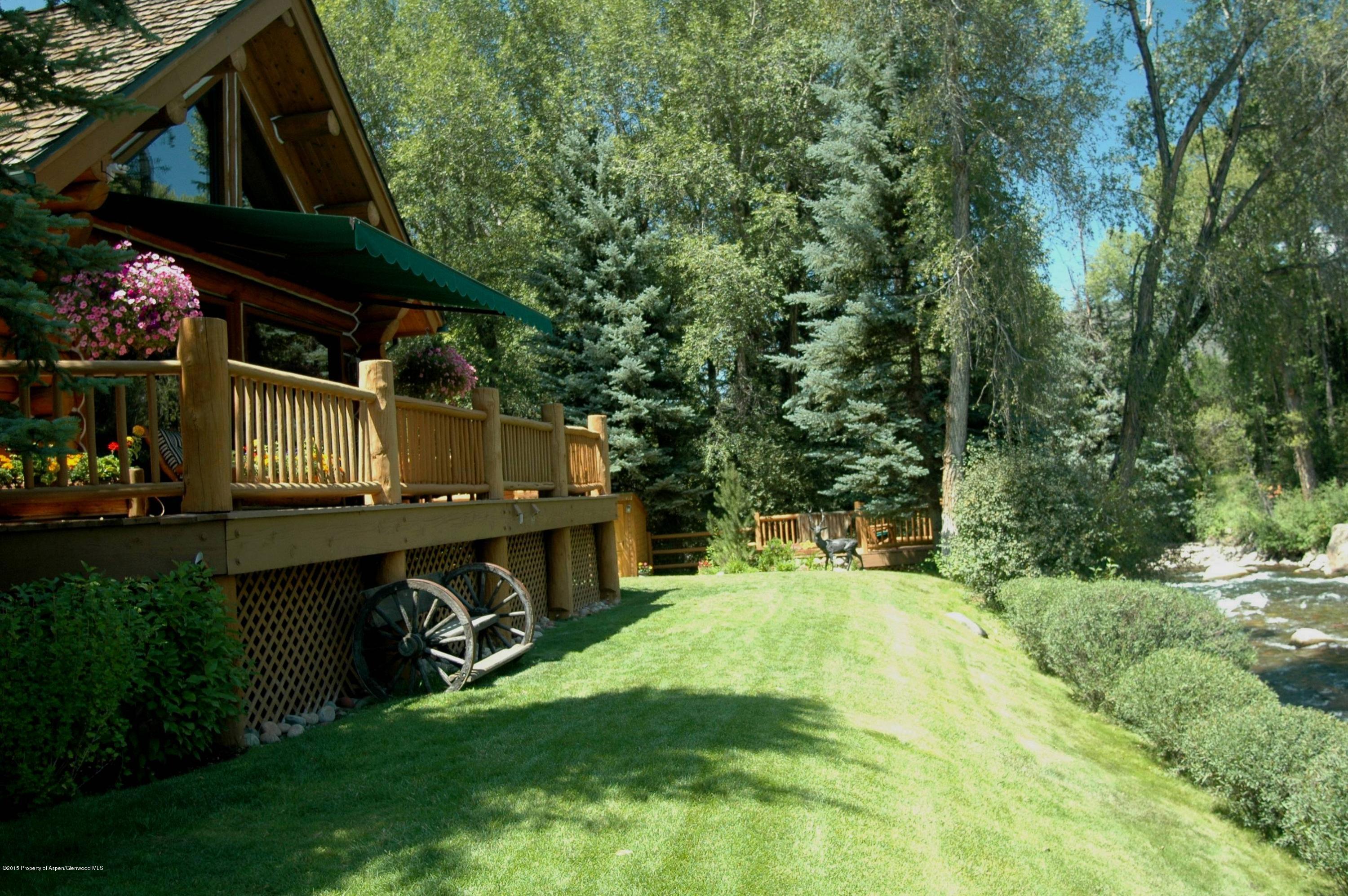 770 Twining Flats Road Woody Creek, CO 81611 - Photo 53 of 59 a view of a backyard with plants and a patio