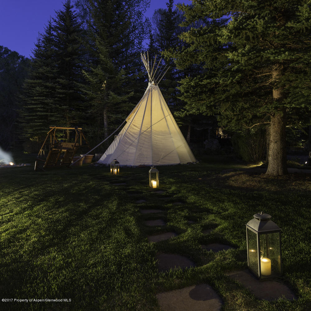 770 Twining Flats Road Woody Creek, CO 81611 - Photo 59 of 59 a backyard of a house with lots of green space