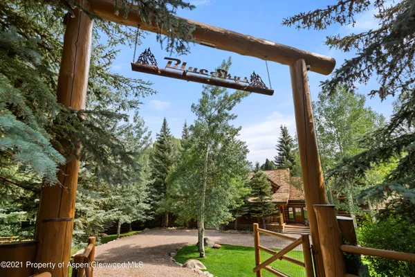 a view of a dining room with furniture a chandelier and wooden floor