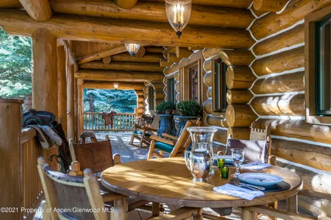 a room with lots of wooden furniture and windows