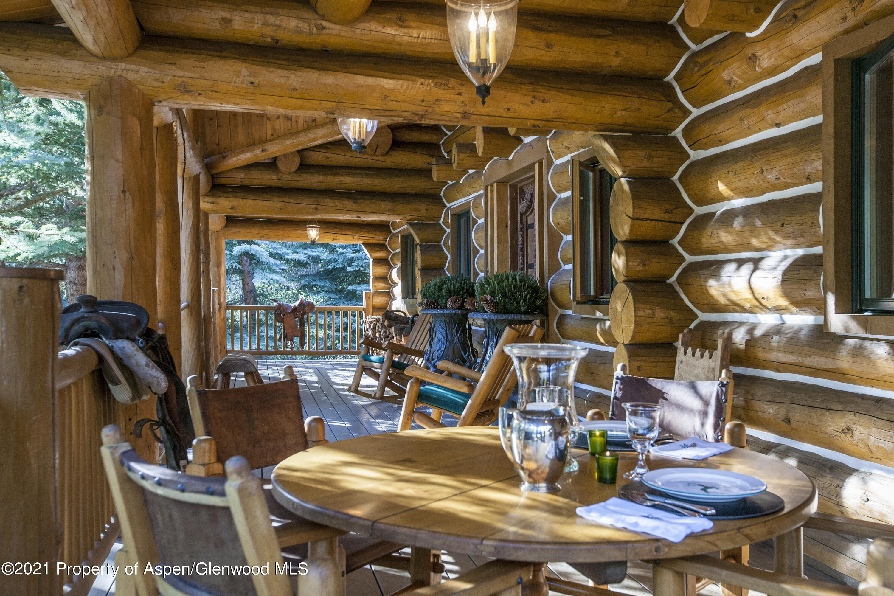 770 Twining Flats Road Woody Creek, CO 81611 - Photo 9 of 59 a view of a dining room with furniture a chandelier and wooden floor