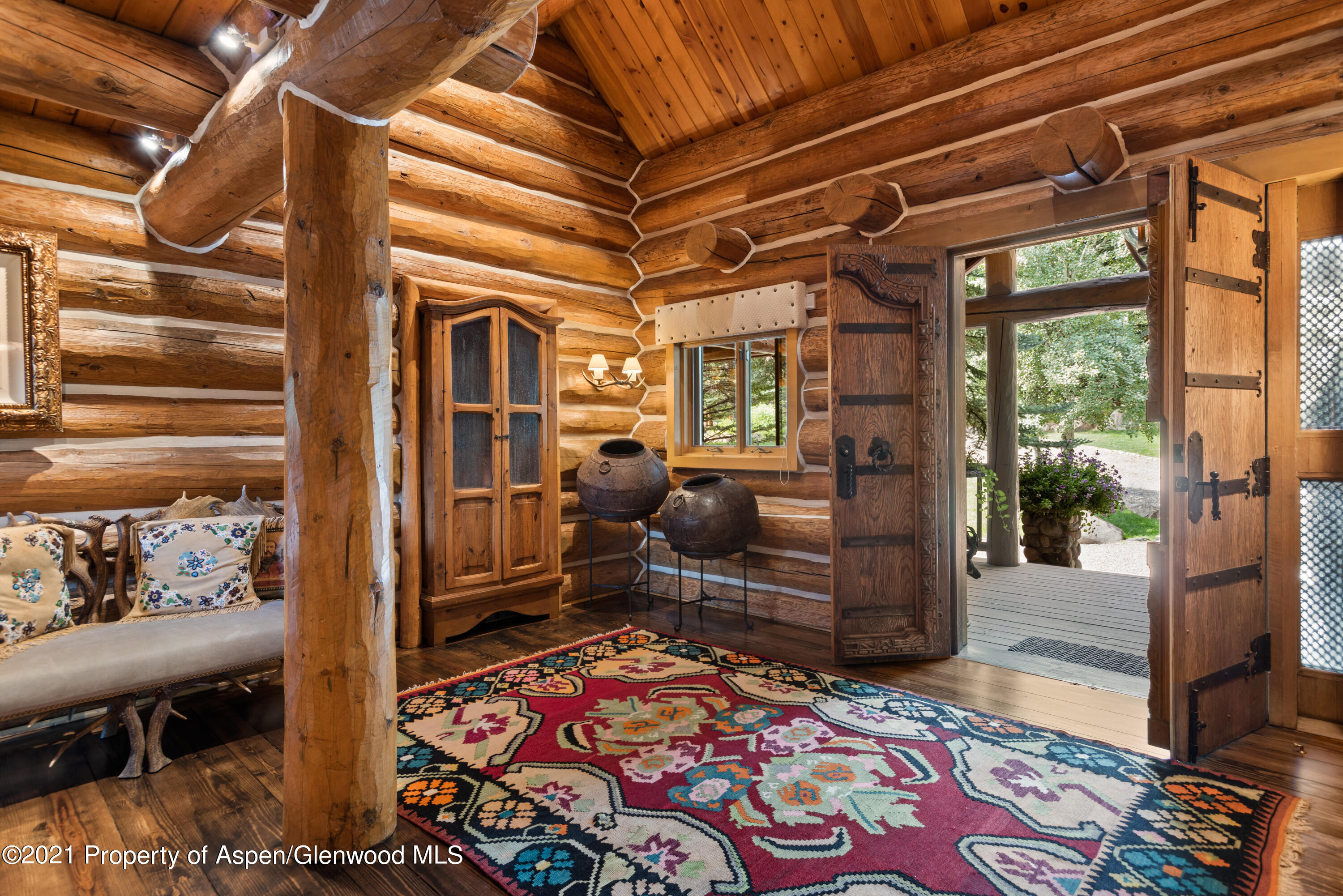 770 Twining Flats Road Woody Creek, CO 81611 - Photo 10 of 59 a room with lots of wooden furniture and windows
