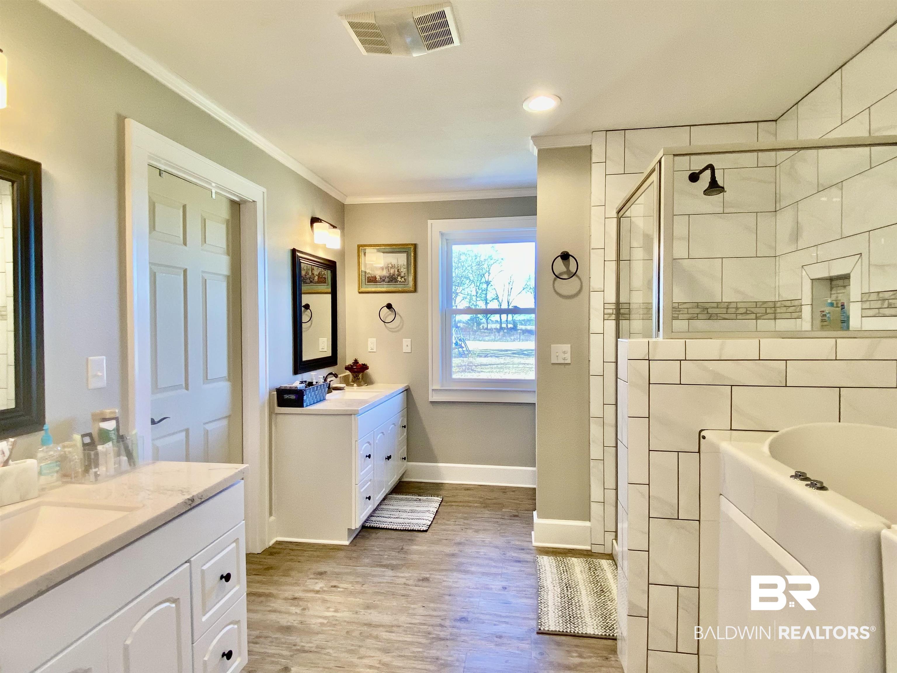 2711 County Road 5 Repton, AL 36475 - Photo 21 of 36 Bathroom with separate shower and tub, vanity, ornamental molding, and hardwood / wood-style floors