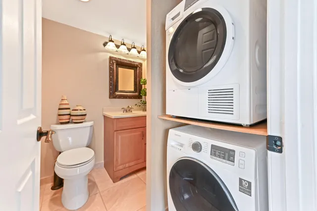 a bathroom with a washing machine and a washing machine
