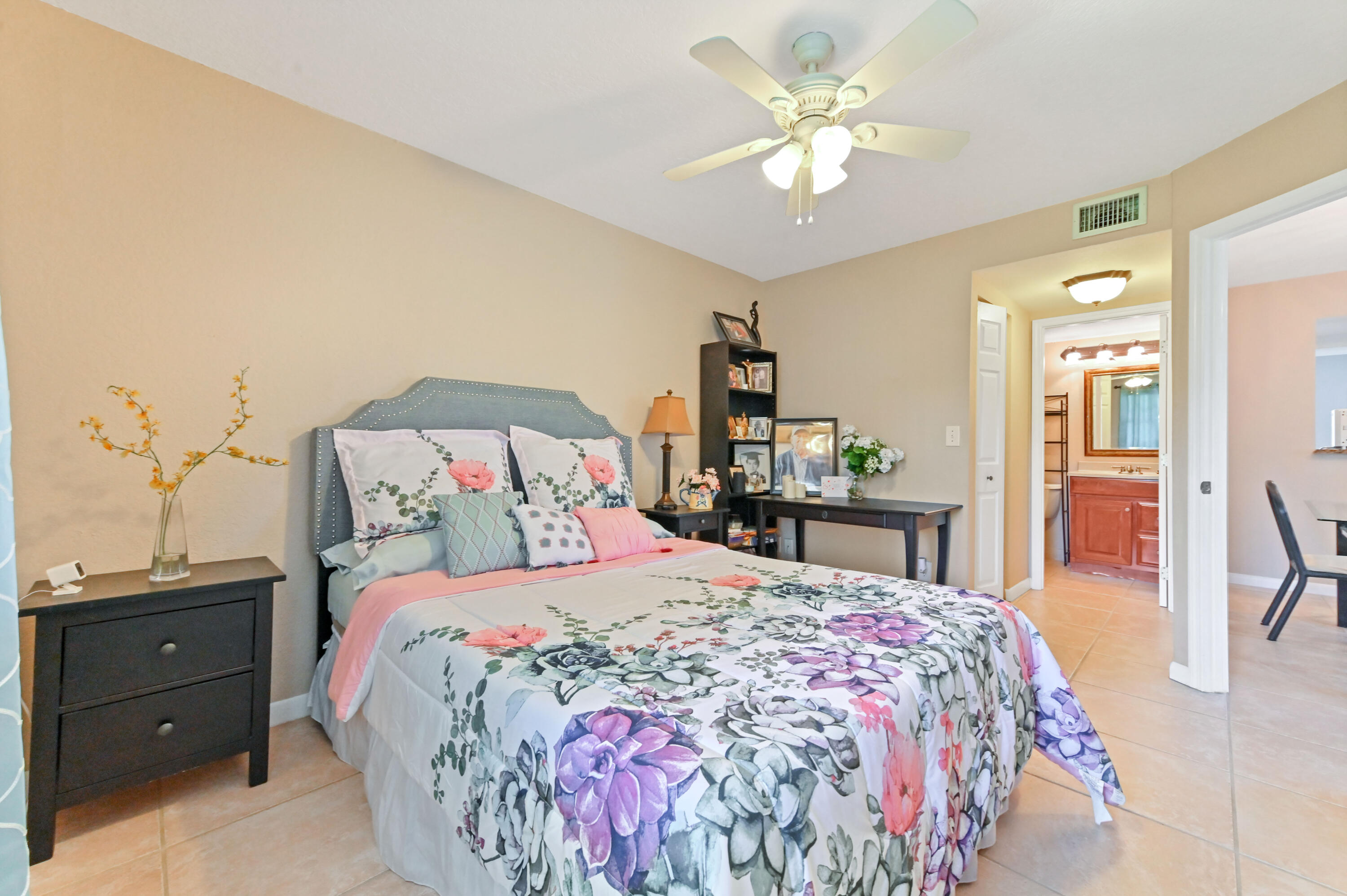 262 Monaco Way Delray Beach, FL 33446 - Photo 16 of 30 a bedroom with a bed and a chandelier
