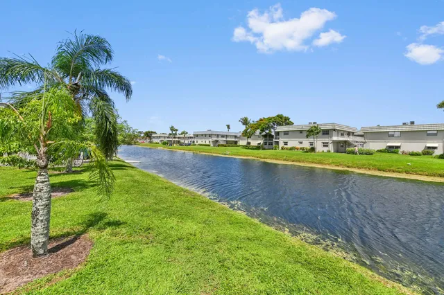 a view of a lake with houses in the background