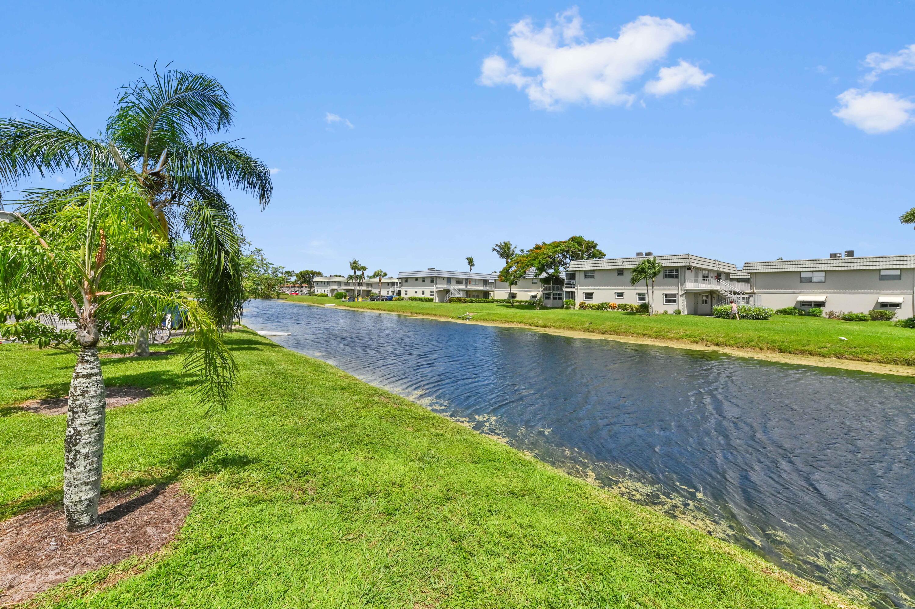 262 Monaco Way Delray Beach, FL 33446 - Photo 2 of 30 a view of a lake with houses in the background