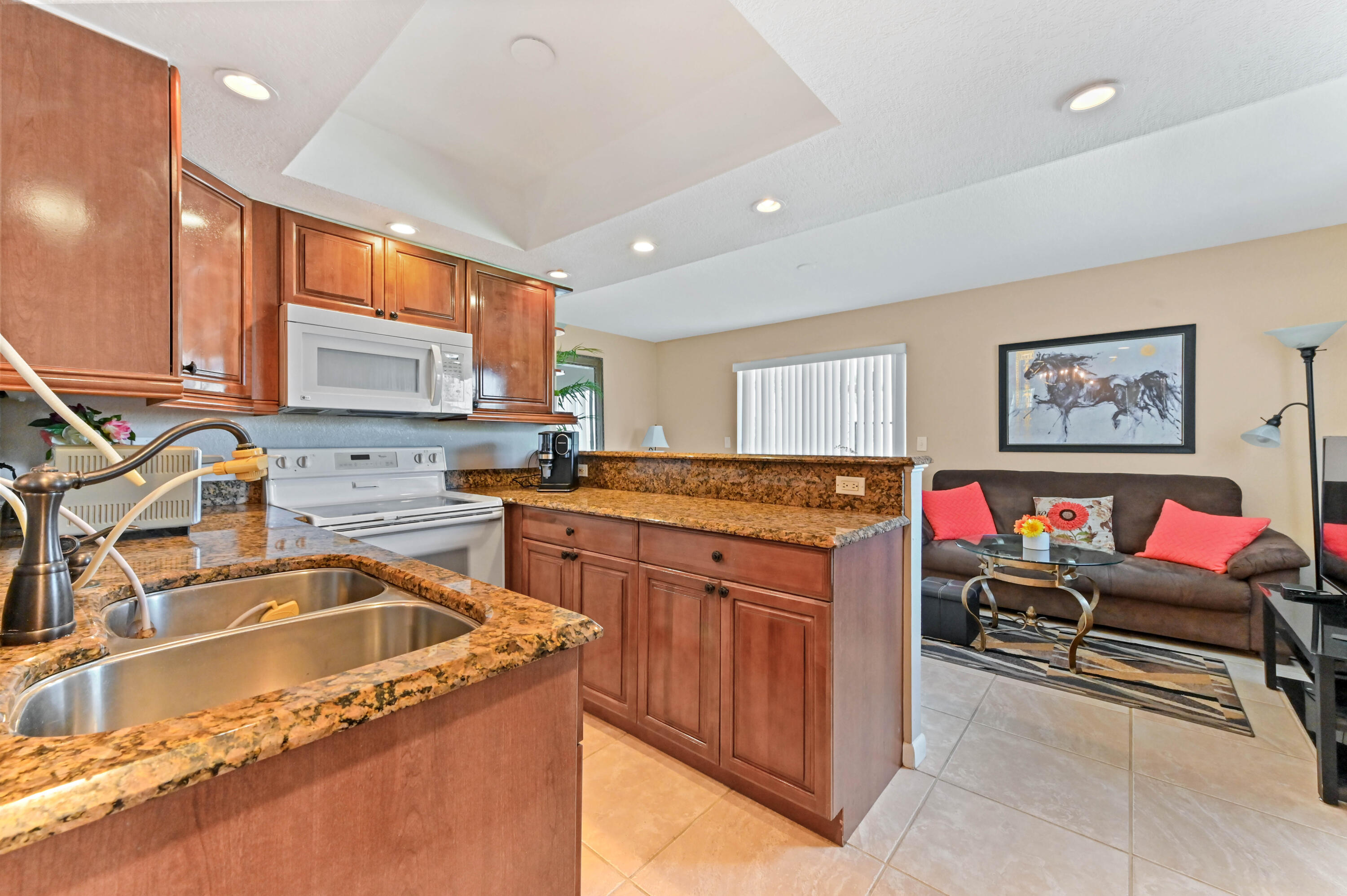 262 Monaco Way Delray Beach, FL 33446 - Photo 5 of 30 a kitchen that has a sink and a stove in it
