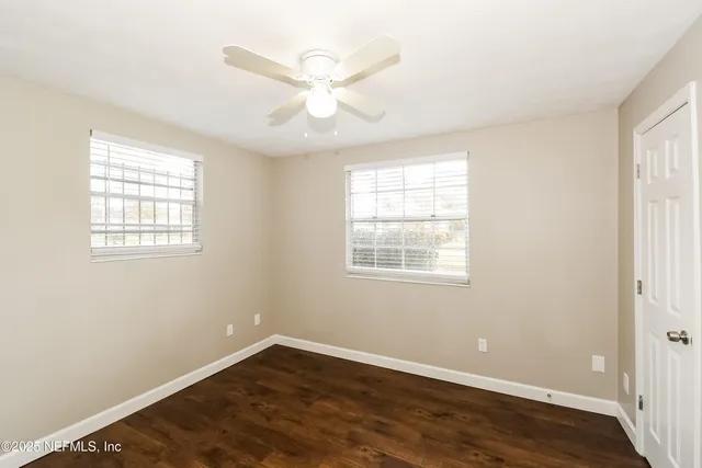 wooden floor in an empty room with a window