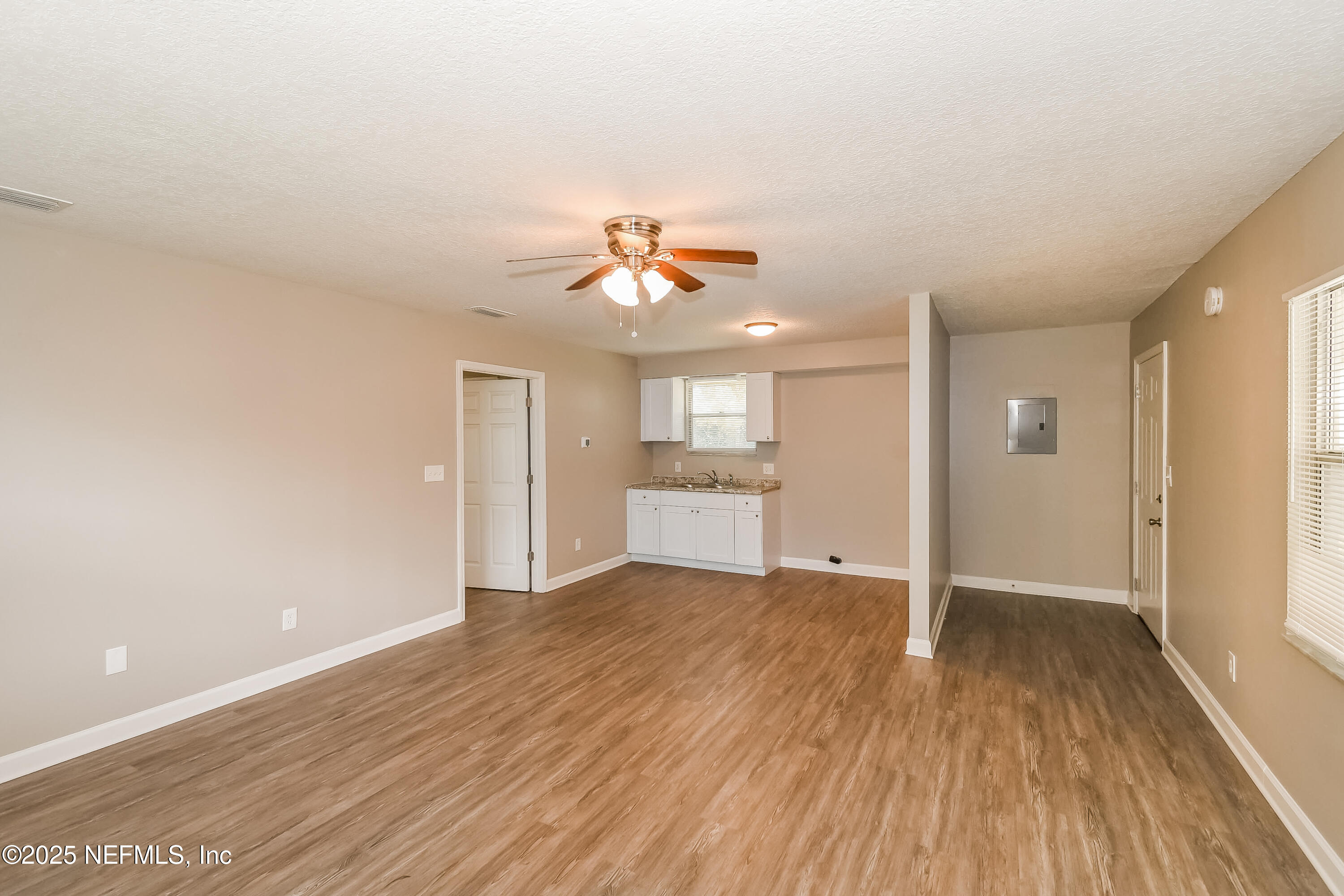 10632 Pinholster Road Jacksonville, FL 32218 - Photo 13 of 15 wooden floor in an empty room with a window