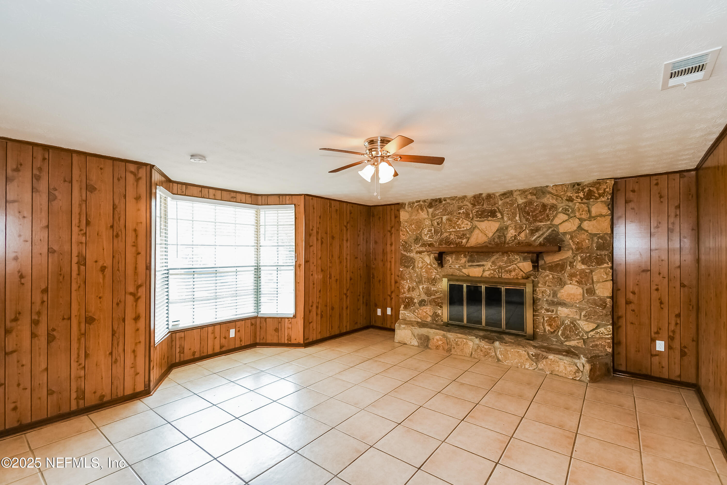 10632 Pinholster Road Jacksonville, FL 32218 - Photo 6 of 15 a view of an empty room with a fireplace and a window