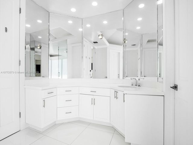 a bathroom with a sink vanity and a mirror