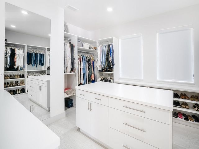 a kitchen with cabinets appliances and a counter top space