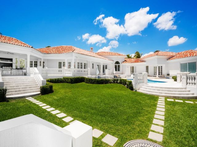 a view of a house with a backyard porch and sitting area
