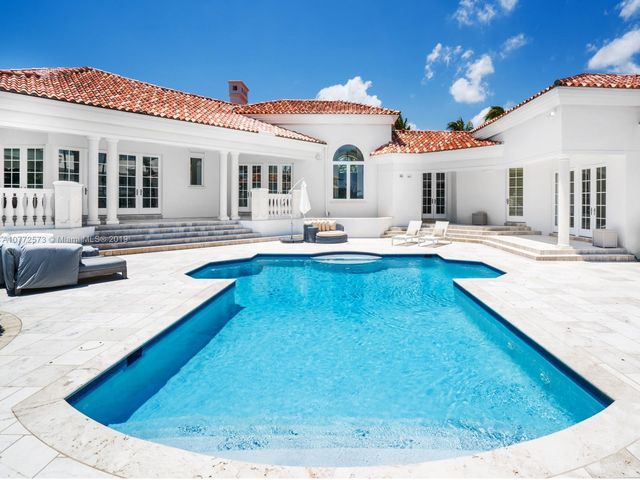a view of a house with swimming pool and sitting area